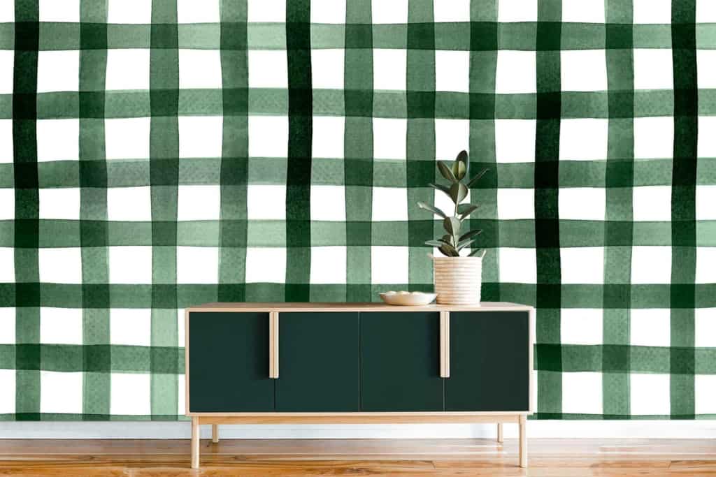 A minimalist interior features a **green and white checkered wall**, adding a vibrant yet balanced touch. The wallpaper's prominent elements include alternating **green squares** and **white squares**, creating a classic checkered pattern. This design emphasizes clean lines and simplicity, perfectly fitting the modern aesthetic while ensuring a timeless appeal.
