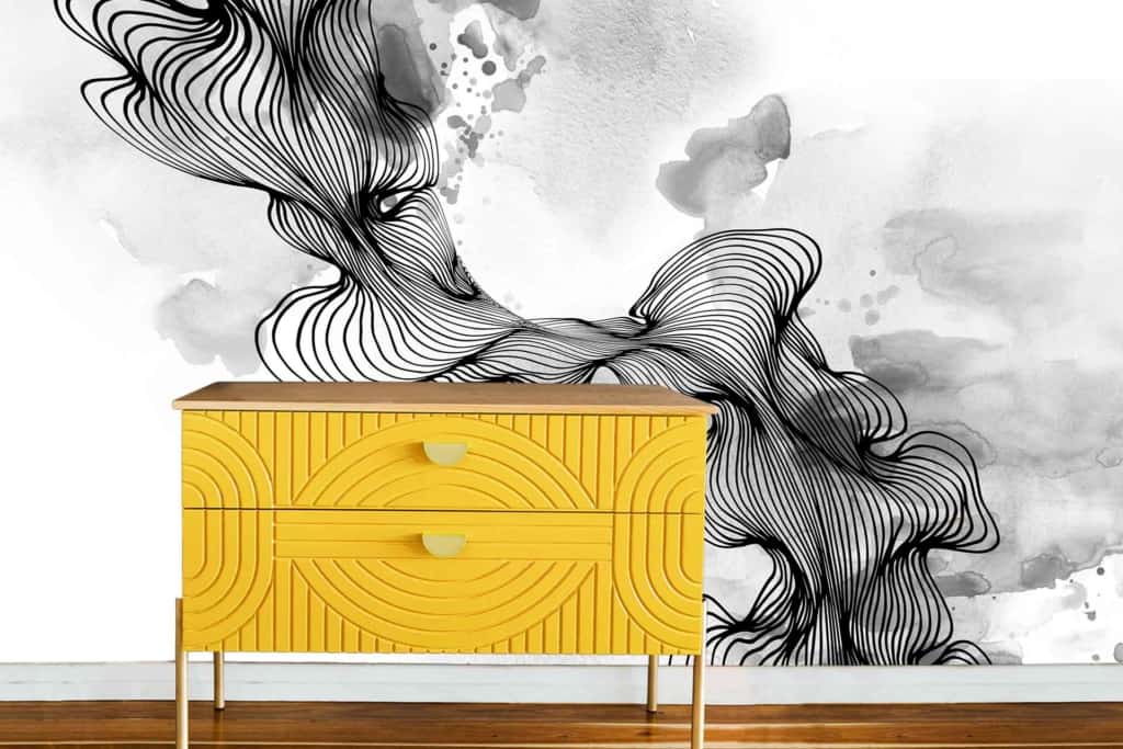An artistic black and white abstract wall mural featuring swirling lines and watercolor textures.
