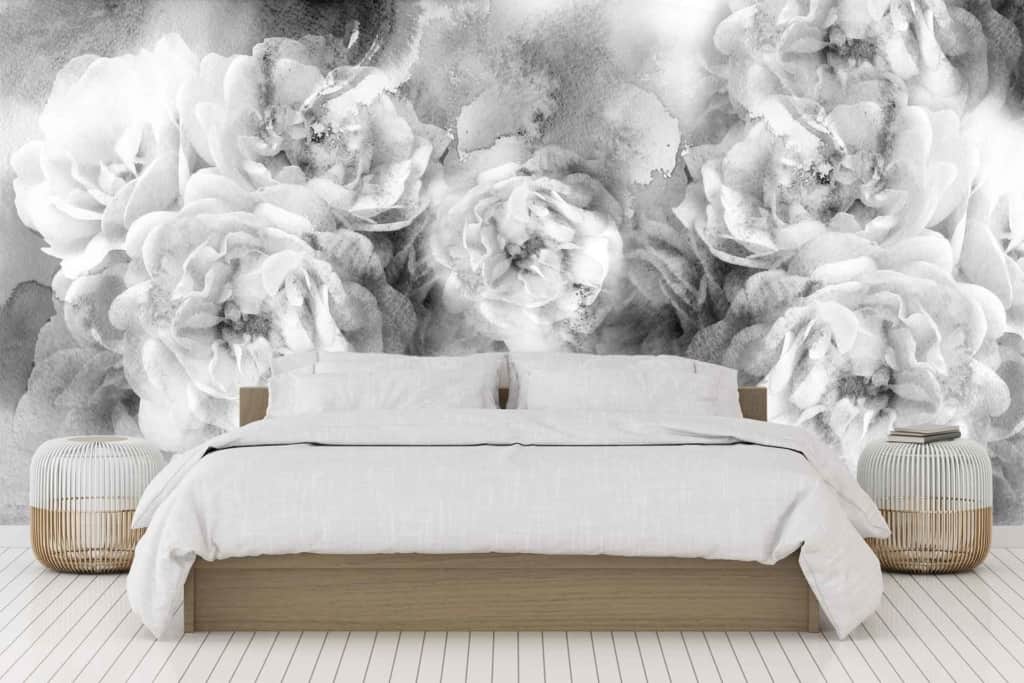 A grayscale floral mural on the bedroom wall features detailed flowers in varying shades of black, white, and gray. The intricate design includes large blooms and delicate petals, creating a striking contrast against the otherwise minimalist room decor.