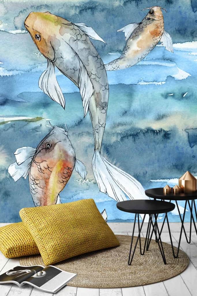 Three koi fish mural: three vibrant koi fish, swimming in various directions. Set against a blue, watercolor-style background. The scene is serene and flowing with hues of orange, white, and black on the koi. A nature-inspired, tranquil ambiance designed to evoke the serenity of a peaceful pond.