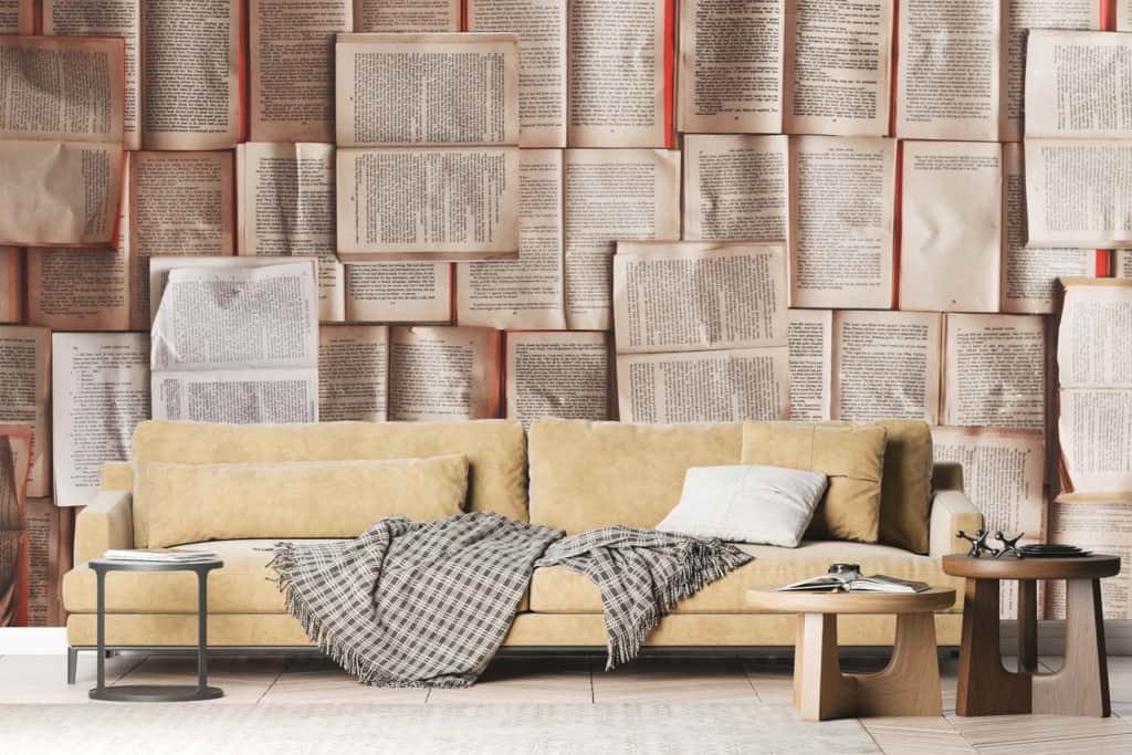 The wallpaper displays a rich tapestry of open books, featuring various shades of beige, brown, and cream with occasional splashes of muted colors. Each book is detailed with realistic textures and shadows, creating a cozy and inviting atmosphere ideal for bibliophiles.