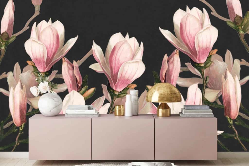 A chic living room features dark floral wallpaper adorned with large magnolia blooms in soft pink and white hues.