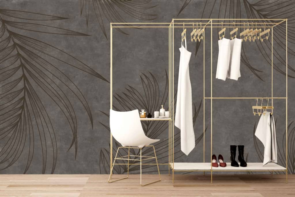 The stylish dark wallpaper features large, elegant leaf patterns in subtle shades of gray and charcoal, creating a sophisticated backdrop. The leaves have intricate details with varying tones, adding depth and texture to the minimalist space.