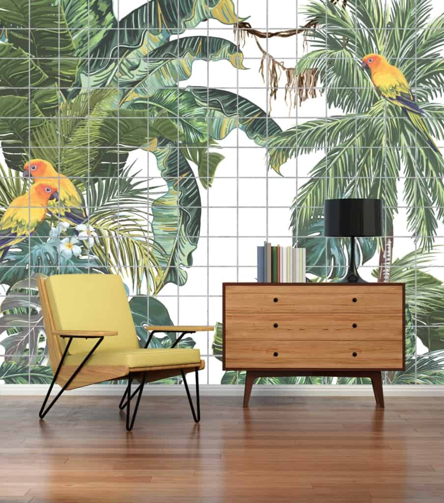 A large wall mural featuring lush Sub Tropicana foliage in vibrant greens, with bright, multicolored parrots in vivid reds, blues, and yellows. Rich botanical elements and tropical bird designs dominate the wallpaper's landscape.