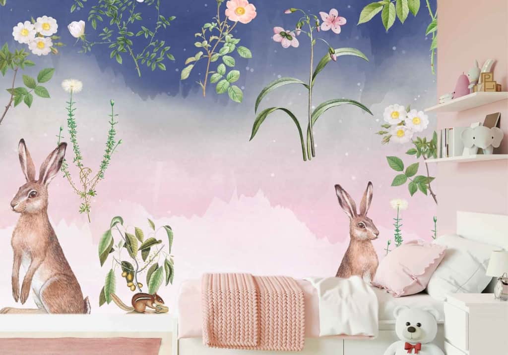 A whimsical children's bedroom wallpaper featuring a Watership Down nature theme with playful rabbits, colorful flowers, and lush plants. The backdrop transitions from a soft gradient blue to pink sky, creating a dreamy atmosphere. This mural beautifully combines elements of nature with vibrant and soothing colors for an enchanting experience.