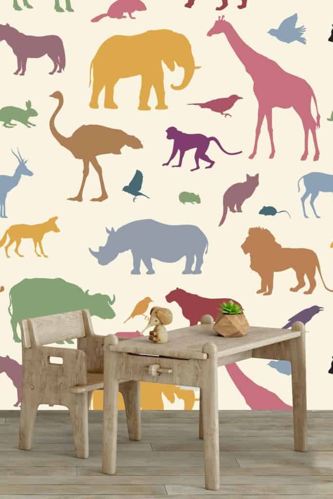 Colorful animal silhouette wallpaper features elephants, giraffes, rhinos, and birds. Bright hues include blue, green, yellow, red, orange. Playful and vibrant design ideal for children's rooms.