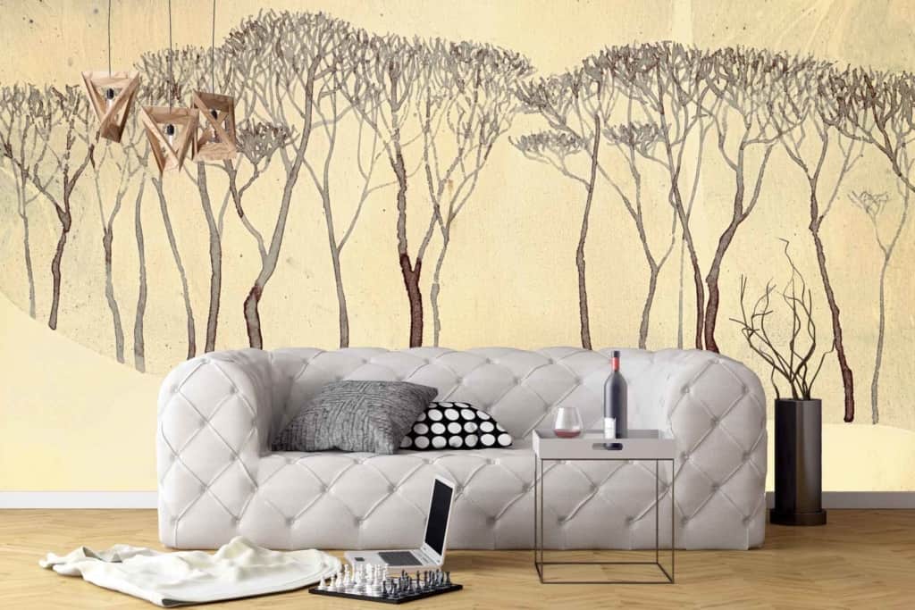 The wallpaper is an abstract forest mural featuring muted earth tones like mossy green, deep brown, and hints of golden sunlight. It includes silhouettes of trees and textured layers that add depth and a nature-inspired atmosphere to the room.