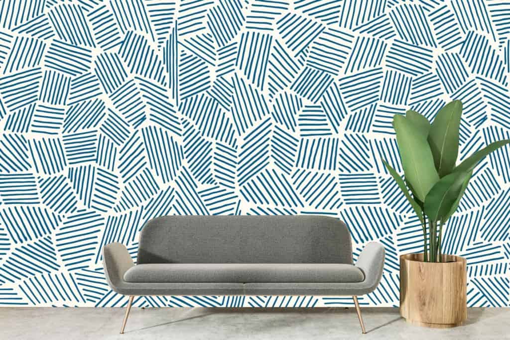 Abstract blue geometric pattern on white wall.
