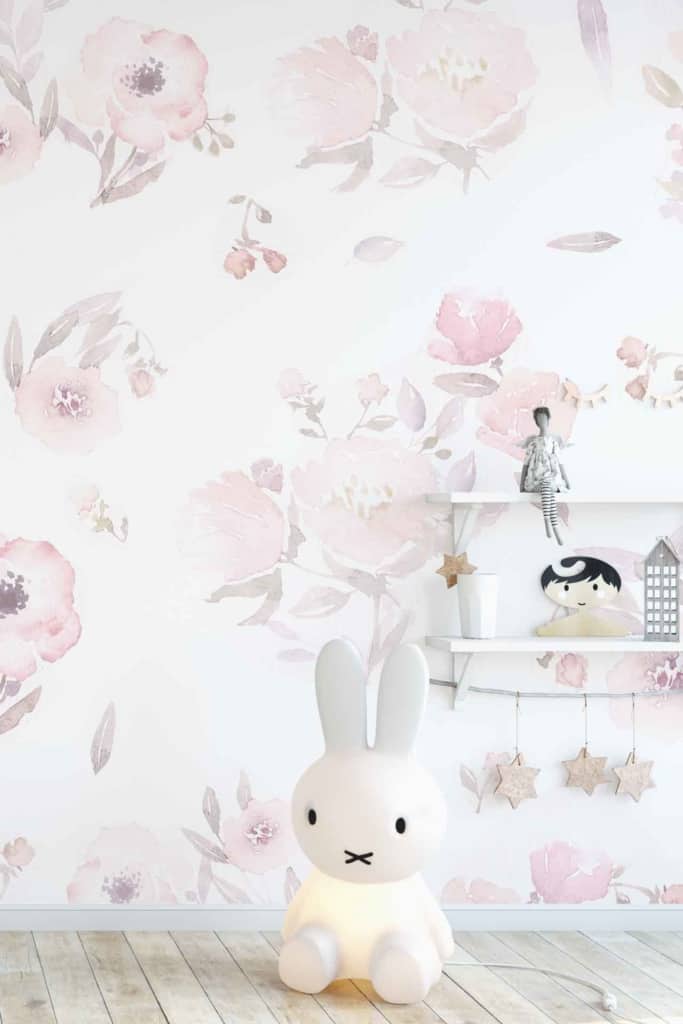 The wallpaper features soft floral patterns in pastel pink and green hues. It includes delicate flowers, subtle vines, and gentle shades that create a whimsical and romantic ambiance perfect for a darling room.