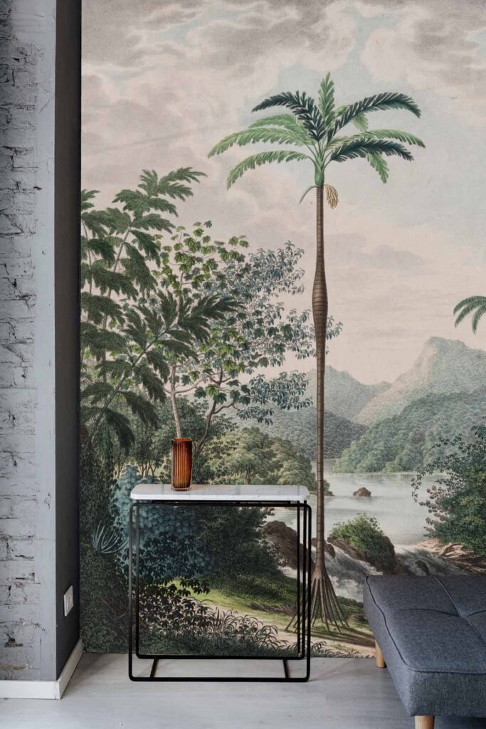 Realistic mural wallpaper of a serene tropical landscape. Features: tall palm trees, lush green vegetation, distant blue mountains. Predominant colors: various greens for vegetation, different shades of blue for the sky and mountains, brown tree trunks.
