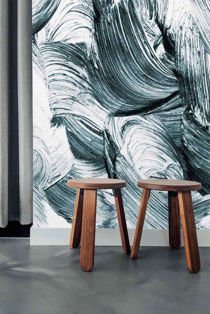 Wall features a bold, abstract black and white brushstroke pattern.