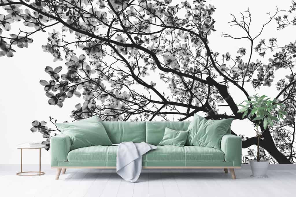 A black-and-white mural of tree branches and blossoms. Elements include tree branches and blossoms with intricate details in monochrome shades. Colors: black and white.
