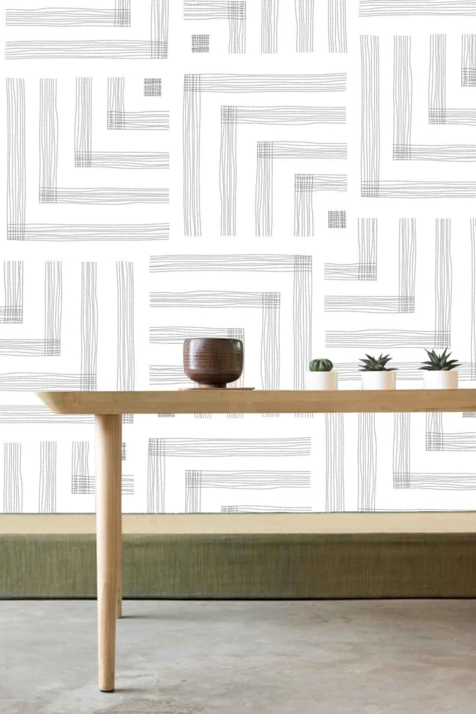 The modern white wall features abstract linear patterns. These lines are subtle yet add depth to the minimalist design. The color scheme is primarily white, with the linear patterns in light grey tones. The overall effect is clean and understated, perfect for a minimalist aesthetic.
