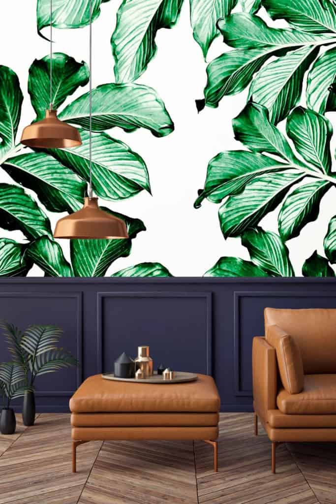 The wallpaper features large green leaves, evoking a lush, natural ambiance. The palette includes various shades of green, from vibrant emerald to deep forest tones. The leafy design has intricate detailing that adds depth and texture. This botanical theme underscores the room's connection to Mother Nature.