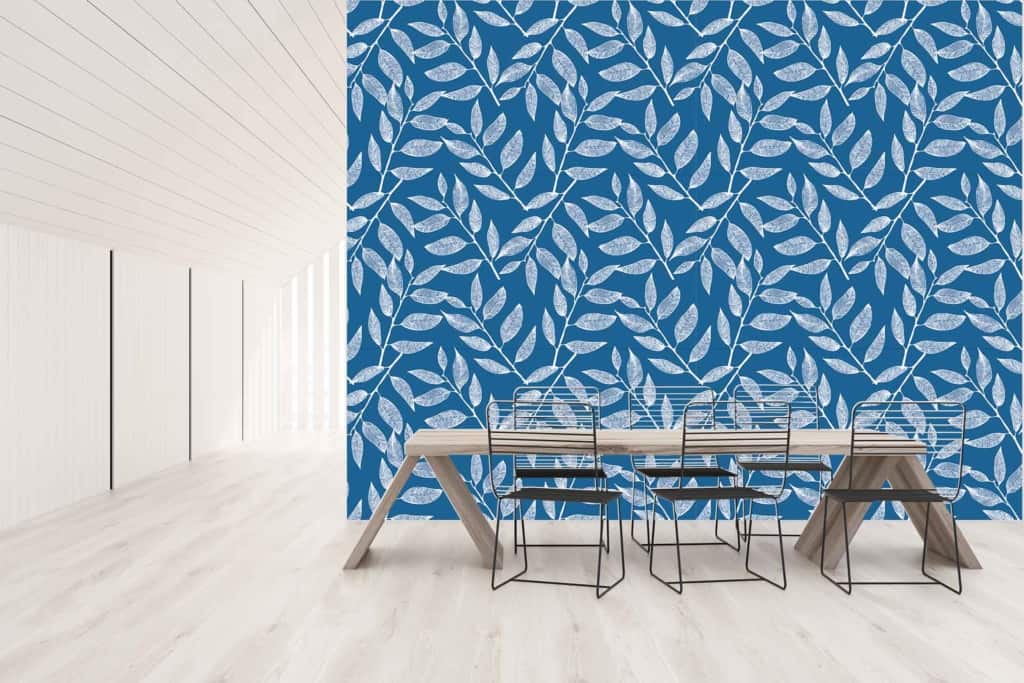 Blue leaf-patterned wallpaper with subtle nautical charm, featuring various shades of blue on a white background. The intricate leaf designs bring contrast to the room's decor.