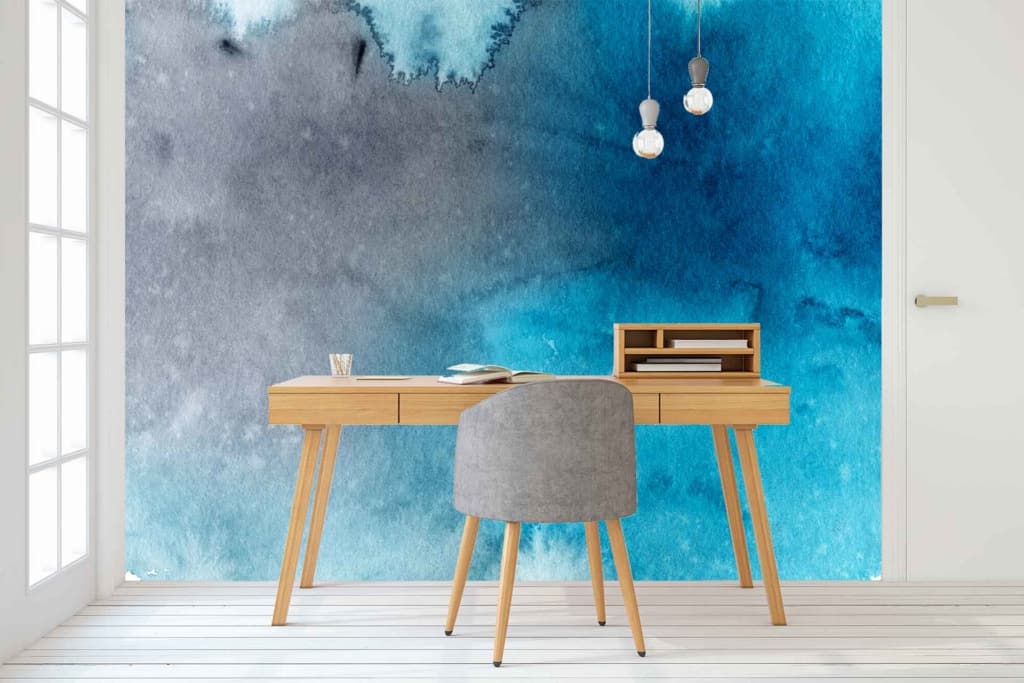 The wallpaper features a vibrant blue and gray watercolor mural resembling an overcast sky. Blue and gray hues blend seamlessly to create a dynamic, cloudy backdrop, adding a splash of color to the clean white space.