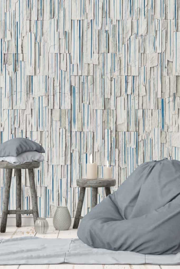 Textured wallpaper with vertical, stacked stone tiles in white and blue.