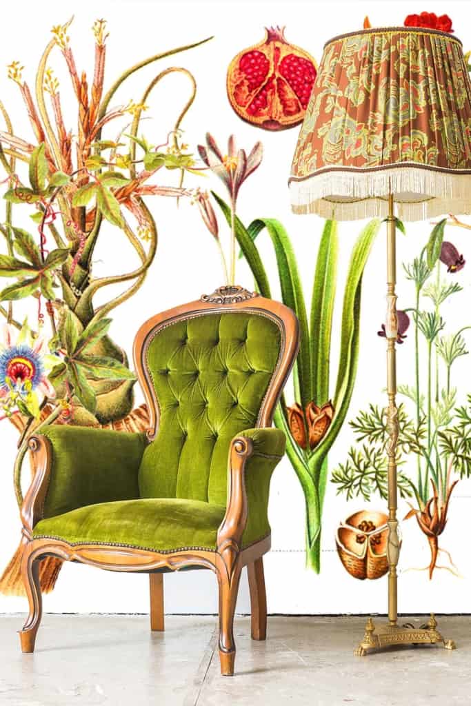 The wallpaper features illustrations of various plants and flowers, including pomegranates, in bright and vivid colors. Multiple leaf patterns are seen throughout the design, adding to its botanical theme.