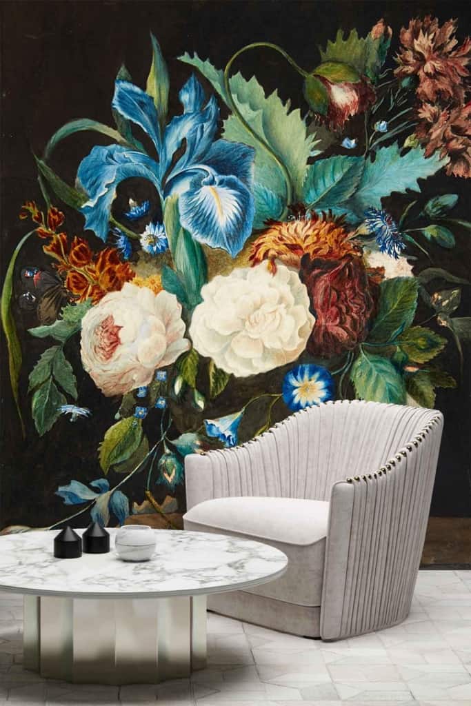 A vibrant, large-scale floral mural in bold colors with blue irises and white roses on a dark background. Elements include blue irises, white roses, and dark backdrop.