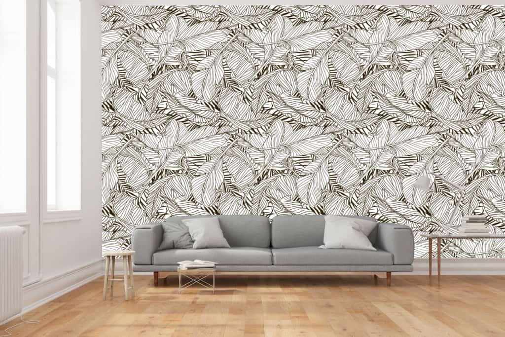 The wallpaper features a bold, black and white leaf pattern. The design consists of large, intricate black leaves set against a crisp white background. The contrast between the black and white creates a striking visual, adding depth and character to the room.