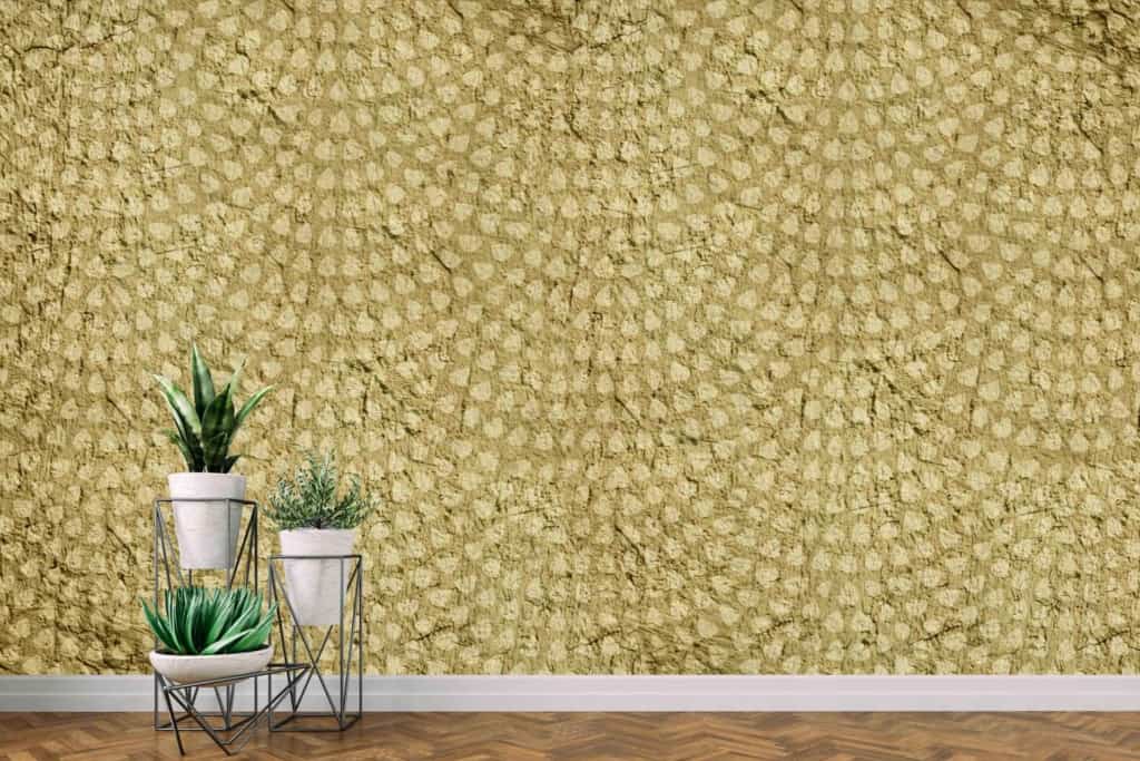 Textured, patterned wallpaper in shades of yellow and gold, intricate designs.
