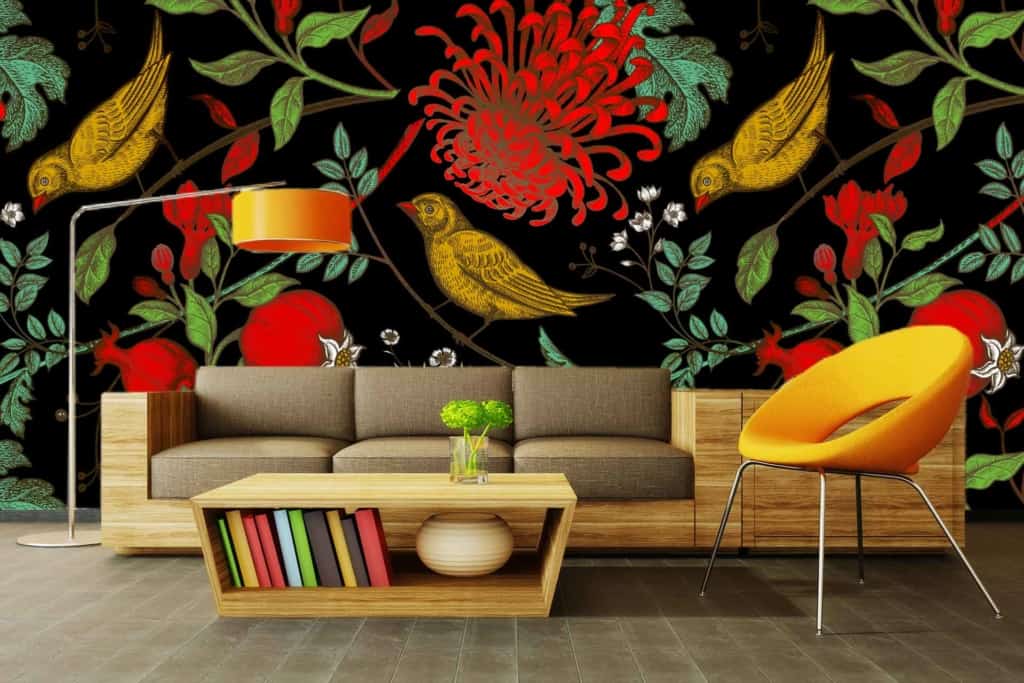 The wallpaper features a bold floral and bird pattern with red, green, and yellow elements set against a black background. Vibrant flowers, lush leaves, and whimsical birds add a touch of nature and color to the space.
