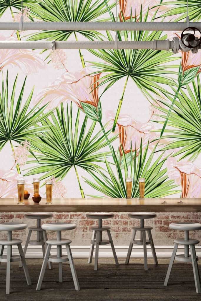 The modern café's wallpaper features a tropical design with lush green leaves and vibrant, colorful flowers in hues of pink, orange, and yellow.