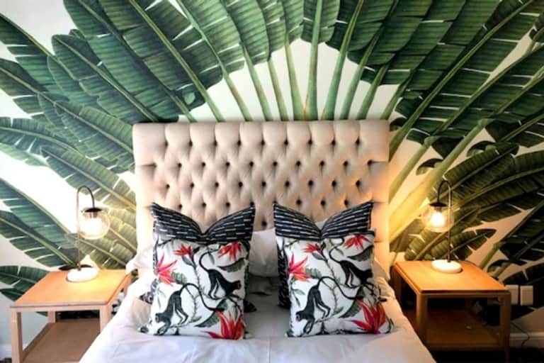 Large green palm leaves, serene backdrop, tropical design.