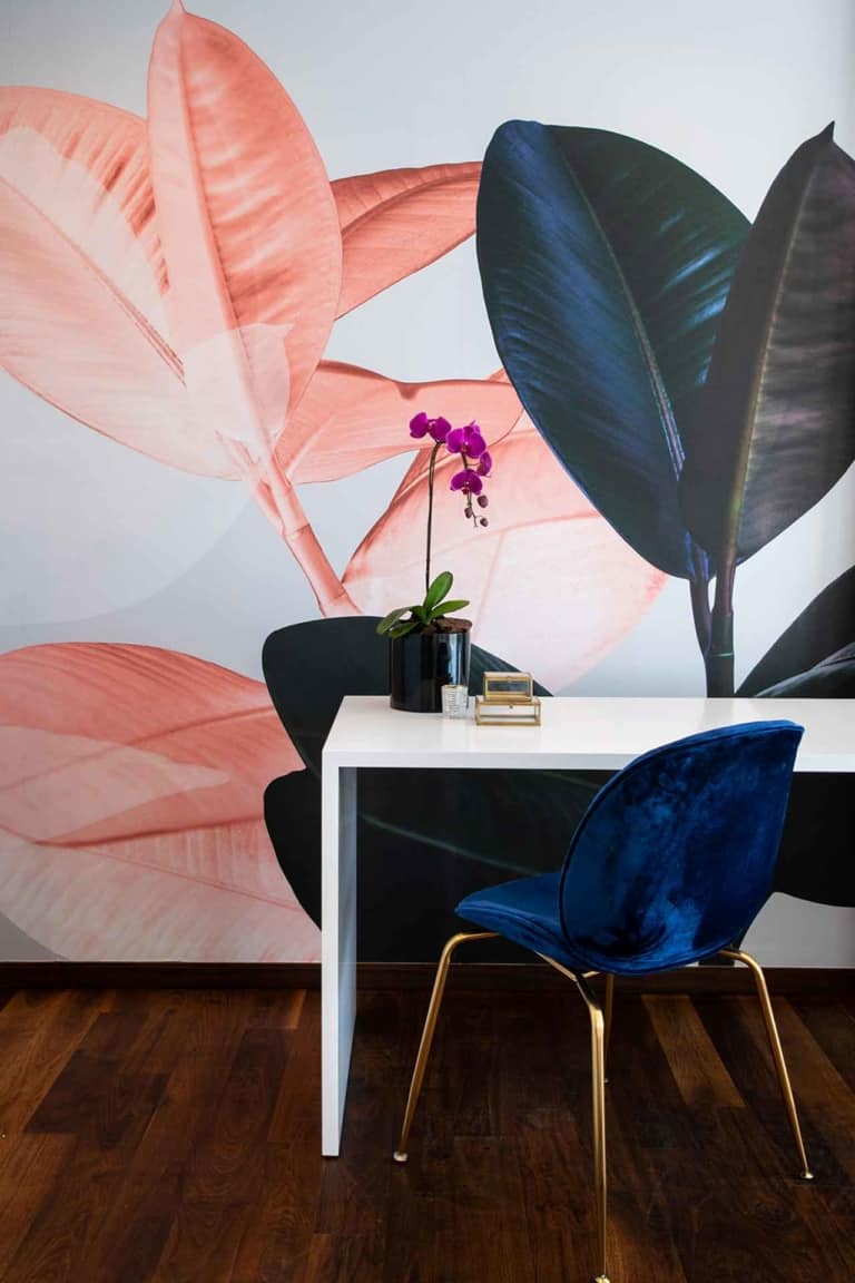 The wallpaper features large, artistic leaf designs with pink and dark green hues. The detailed patterns in vibrant pink contrast beautifully against the rich, deep green, making it visually striking and inspirational.