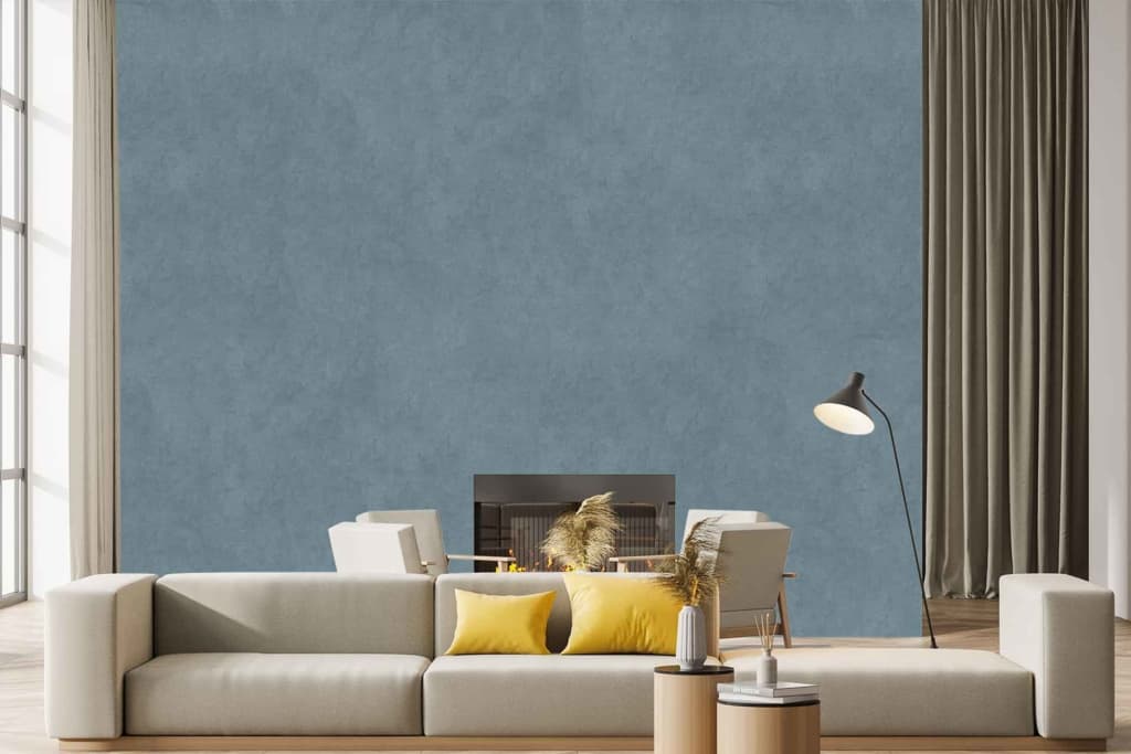 The wallpaper features a textured blue design, adding depth and sophistication to the room. Various shades of blue create a gradient effect, with subtle hints of teal and navy interwoven. The texture mimics natural fibers or brush strokes for an artisanal feel, complementing the overall modern decor.