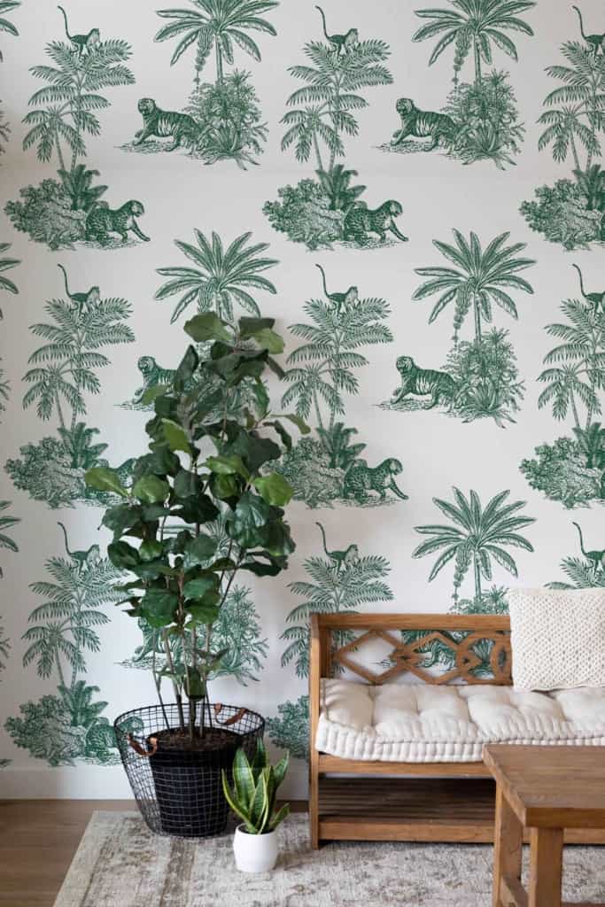 The wallpaper features a jungle theme with vibrant green palm trees, creating a lush backdrop. Lounging wild animals like leopards and monkeys add an exotic touch amidst the foliage. Swallows in flight across the ceiling introduce whimsical, dynamic elements to the scene. The rich greens of the palms and earthy tones of the animals provide a lively yet natural aesthetic.