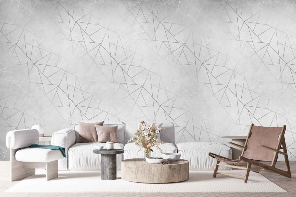 The wallpaper in the modern living room features a geometric pattern of intersecting lines on a white background. It blends clean, sharp angles with a sophisticated design, offering an element of wild sophistication reminiscent of silverback elegance. The intersecting lines create dynamic shapes, adding depth and visual interest while maintaining a minimalist aesthetic through its monochromatic color palette.