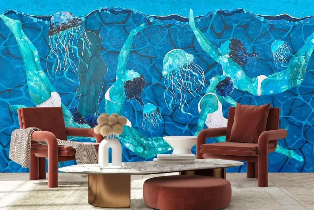 The wallpaper features a vibrant blue backdrop with dynamic elements, including swimmers and jellyfish. The aquatic scene is rich in oceanic hues and highlights the fluid movement of underwater life.