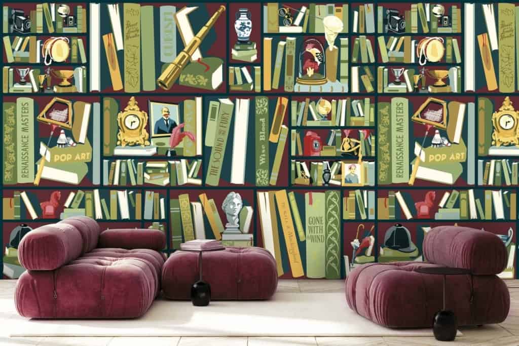 Colorful wallpaper featuring shelves filled with books, vintage items, and art pieces. Highlights include prominently visible books on Renaissance Masters and Pop Art. Warm tones with plush burgundy seating and small stools in the foreground, creating a cozy reading nook reminiscent of an inviting library. Rich hues of red, gold, blue, and green dominate the palette.