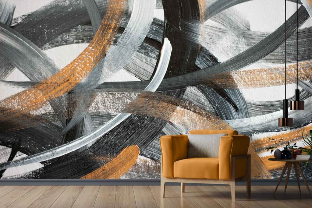 The wallpaper features abstract art with bold brushstrokes in black, grey, and gold.