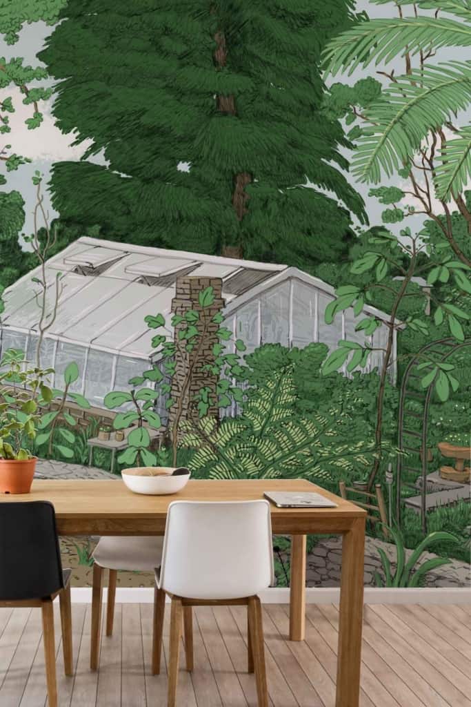 A stunning wall mural showcases a lush green garden with dense foliage, tall trees, and various plants. A prominent glass greenhouse is surrounded by greenery, creating a serene, nature-inspired ambiance. The mural features shades of green, hints of brown from the tree trunks and soil, and touches of vibrant colors from blooming flowers.