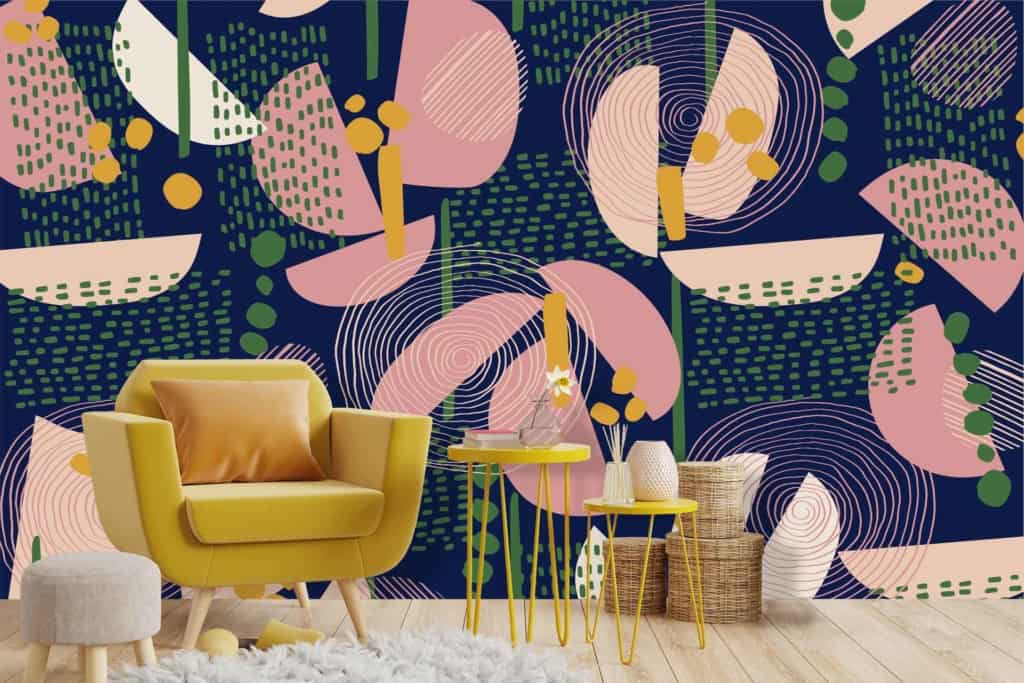 Abstract patterned wallpaper with geometric shapes in pink, green, and white on a navy blue background.