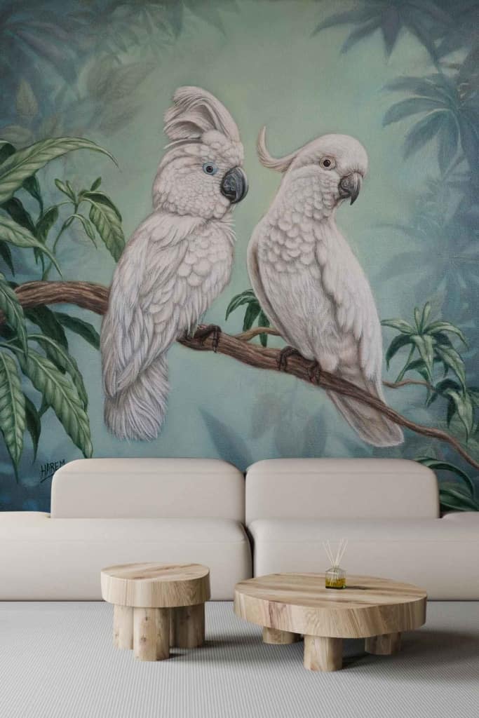 The wallpaper features a large mural of beautiful birds perched on a branch, surrounded by lush green foliage. The birds are intricately detailed, showcasing vibrant colors such as blues, reds, and yellows. The lush foliage includes various shades of green leaves and delicate flowers in pastel hues. The overall effect is natural and serene.