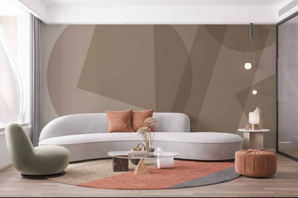 A modern living room features wallpaper with a **subtle geometric pattern**. The design includes **delicate lines and shapes** in shades of **soft grey, muted white, and light beige**. These elements create an understated elegance that blends seamlessly with the contemporary decor of the space.
