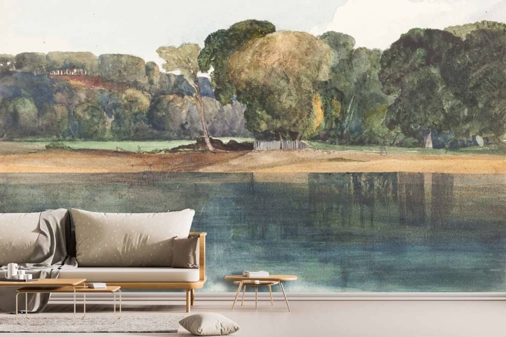 The wallpaper features a serene lakeside landscape with calm waters, lush green trees, a fallen tree by the shore, and a peaceful sky. Predominant colors are shades of blue for the water and sky, various greens for the foliage, and brown tones for the fallen tree.