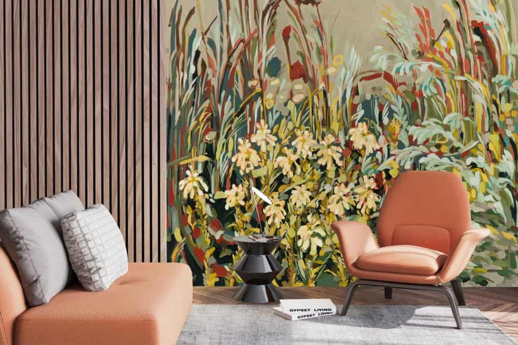 A modern living room features a colorful mural of flowers and grasses on the wall. The mural includes vibrant hues of red, yellow, green, and blue.