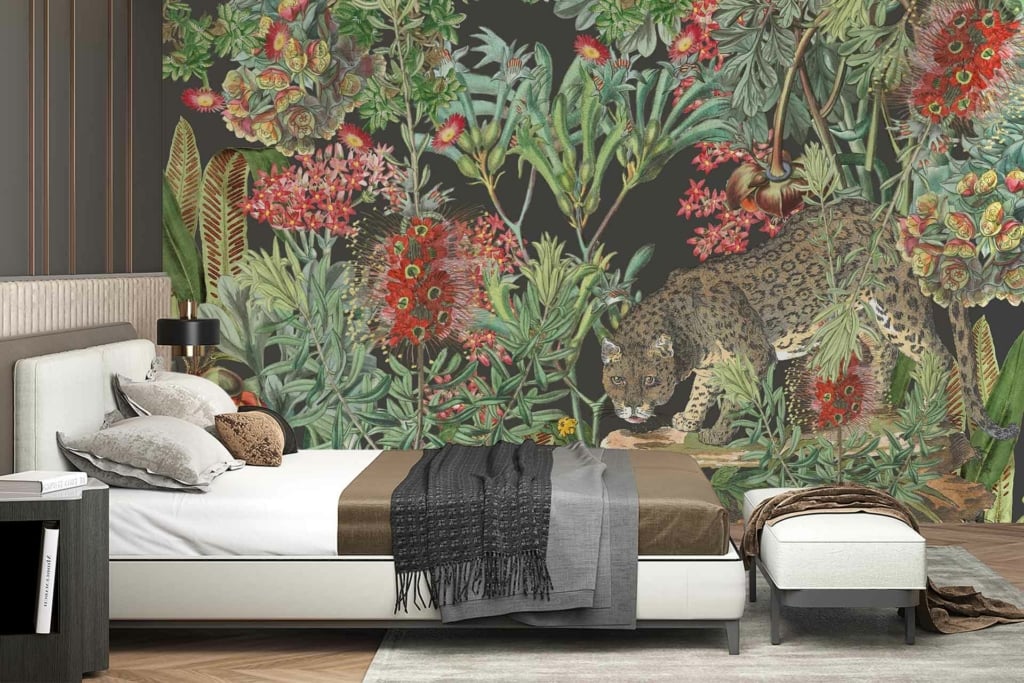 A lush jungle scene wallpaper featuring a leopard positioned amidst vibrant, tropical plants and flowers. The mural showcases rich green foliage, colorful blooming flowers in reds, pinks, yellows, and oranges. Browns highlight the leopard's fur spots blending seamlessly with earthy tones of the forest floor.
