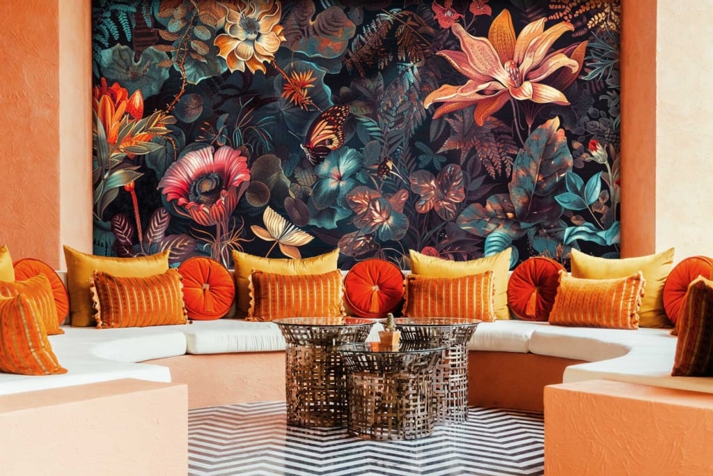 Vibrant, large floral mural; colorful flowers; peach hues; dark leaves; creative force.