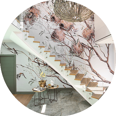 Nature-themed mural with birds and nests on tree branches, featuring a palette of greens, browns, and soft blues.