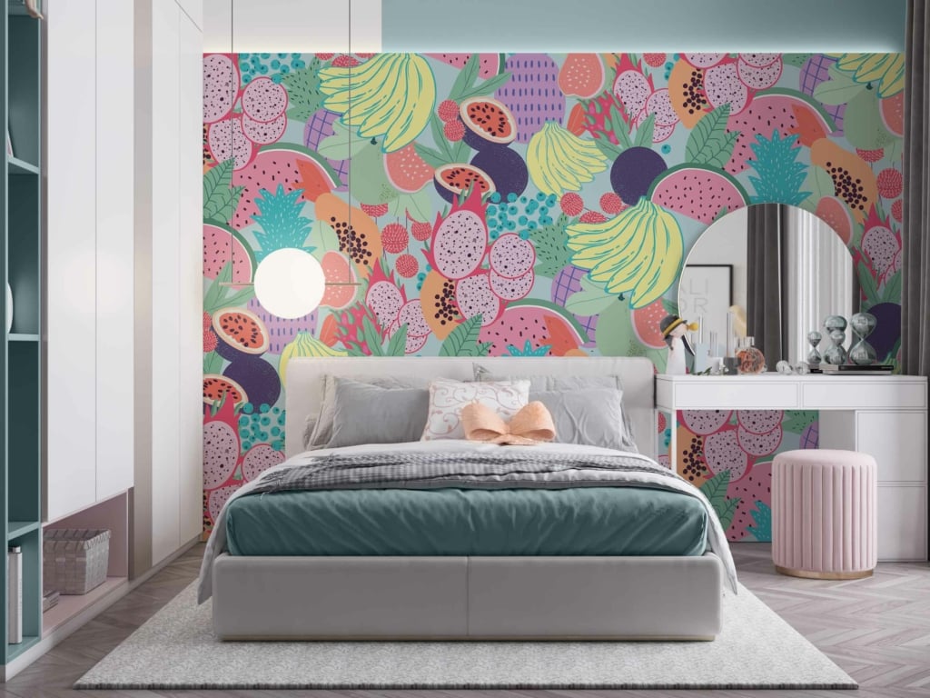The wallpaper features a playful, colorful fruit-themed mural with vibrant hues of red, yellow, green, and orange against a soft background. The elements include various fruits such as pineapples, strawberries, bananas, and apples.