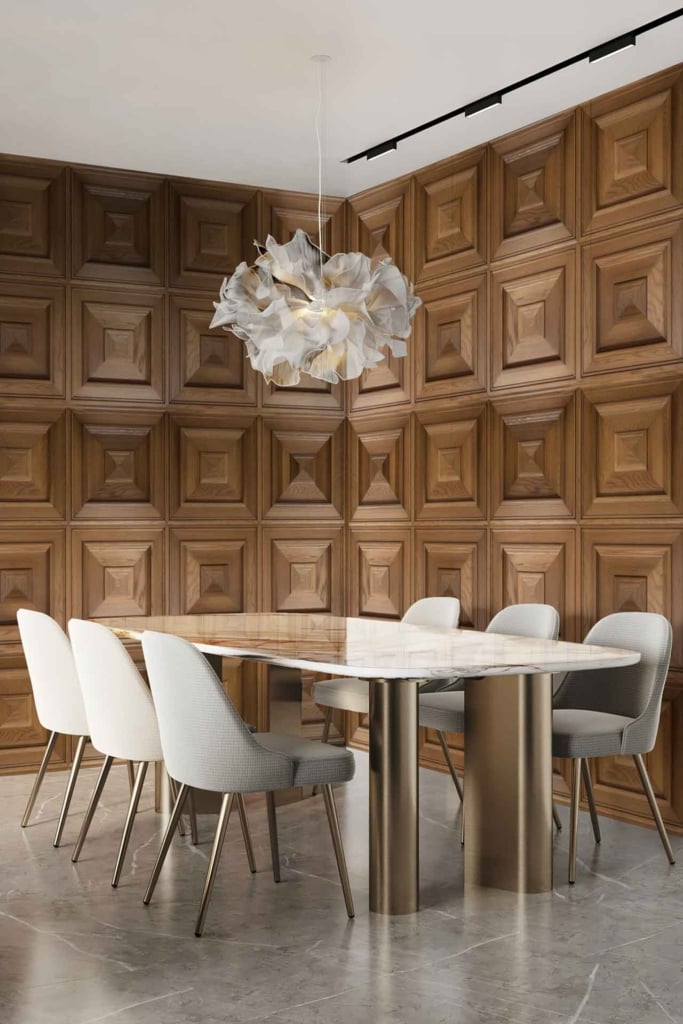 A modern dining room featuring a geometric wooden wall comprising various triangular and diamond-shaped patterns in natural wood tones like oak, walnut, and teak. The warm, earthy hues contrast with subtle darker shades for depth, creating an eye-catching backdrop.