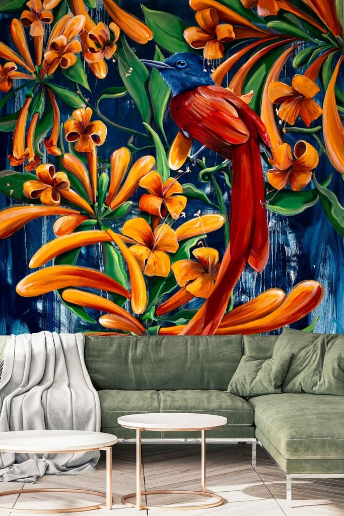 The vibrant mural wallpaper features a colorful bird with red-orange plumage and a blue head, surrounded by lush, abstract orange flowers and green foliage.