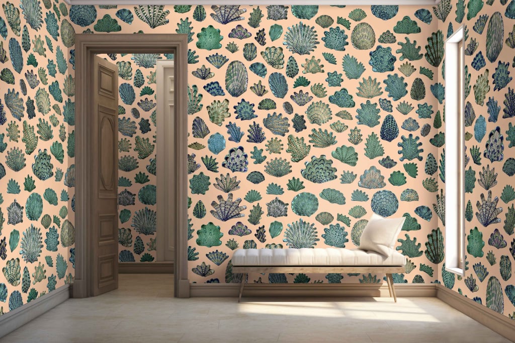 The wallpaper features a striking floor-to-ceiling coral reef pattern in various shades of blue and green on a light beige background. The design includes intricate coral formations, delicate seaweed tendrils, and subtle hints of marine life blending seamlessly into the calming backdrop.