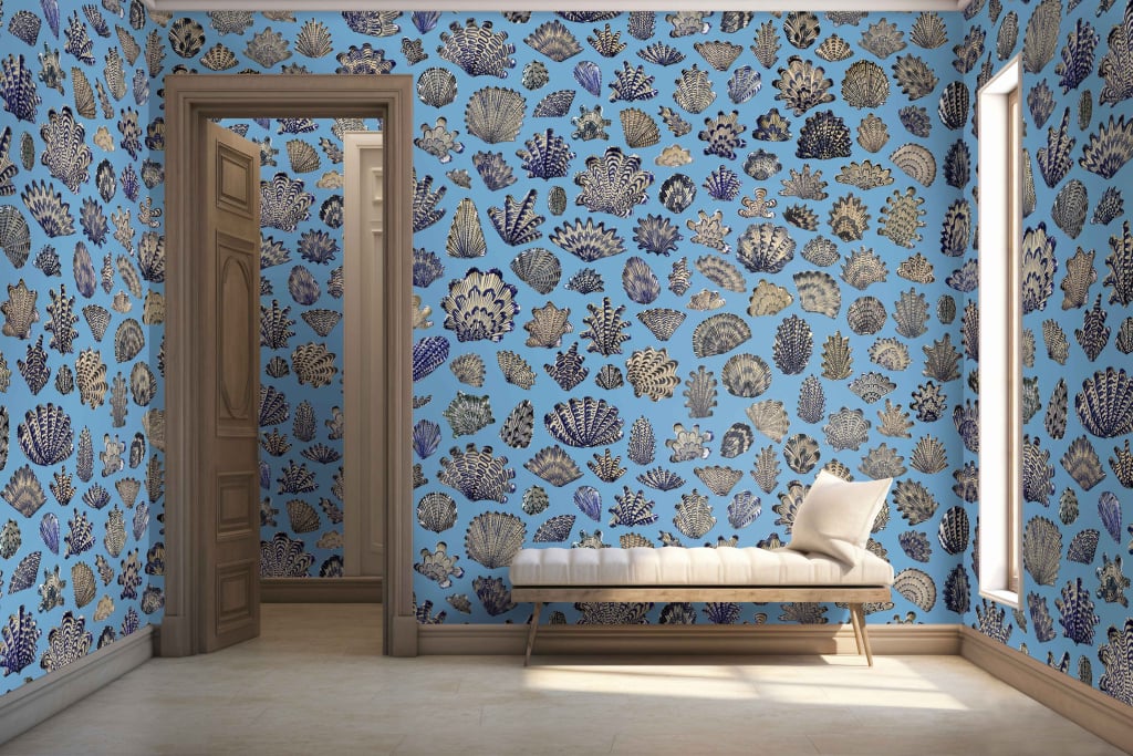 Vibrant blue wallpaper; adorned with various sea shell patterns.