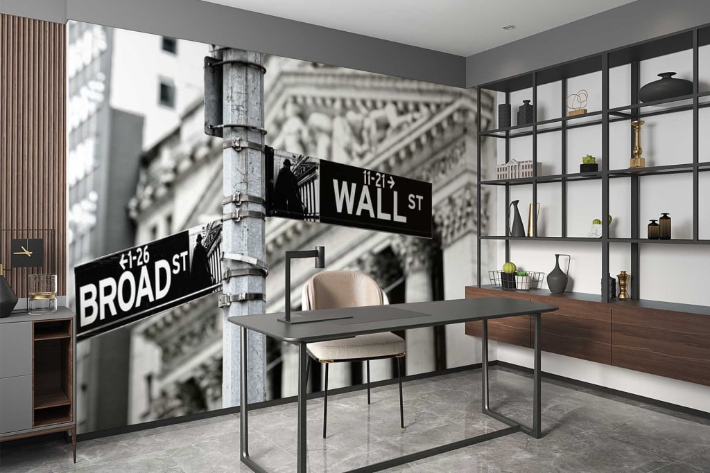 The wallpaper features a large mural depicting street signs for Wall St and Broad St. It includes urban elements such as road markings, street lights, and building silhouettes. The colors are muted with a focus on grayscale tones accented by blacks and whites, emphasizing a neutral yet urban aesthetic.